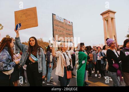 MALAGA, SPAIN - MARCH 8th, 2020: People celebrating 8m women`s day with banners and placards, during feminist strike in Malaga, on March 8 th, 2020.